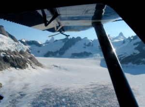 Flying over an ice field with notorious Devils Thumb peak in the background.